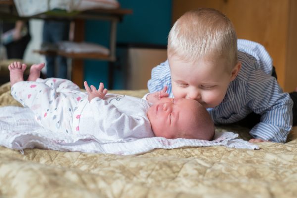 Brother kissing new sister